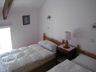 Upstairs bedroom with two single beds
