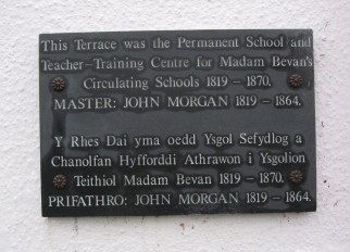 Plaque attached to a row of houses in College Square, Newport, Pembs.